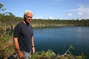 Jeremy Wade standing by the edge of blue hole Captain Bills Blue Hole, Andros, Bahamas.
