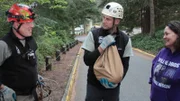 Shaun Sears holds a safely rescued Indy while chatting with Tom Otto and owner, Tricia Joy.