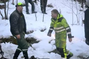 Odda, Norway - (Left to Right) Jarle Hauksland and Thord Paulsen. Jarle Hauksland is a local guy helping Thord to rescue the trash truck that has one of the wheels in the ditch. They are planning how to do the operation.