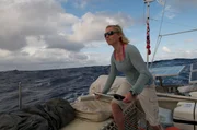 Skipper Jo Royle at the Helm of the Plastiki.
(Photo Credit: Max Jourdan)