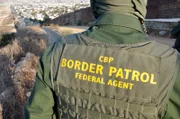 SAN DIEGO, CA, USA: A border patrol agent surveys the international boundary that separates San Diego from Tijuana. This San Ysidro border crossing is the busiest in the world, with over 40 million people entering the U.S. through this port in 2005 alone.