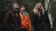 Shaun Sears and Valerie and son, Kalen Kelly stare up at Pepper stranded in a tree.