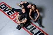 Designer Chip Foose with Co-hosts Courtney Hansen and Chris Jacobs on top of the Overhaulin' logo.