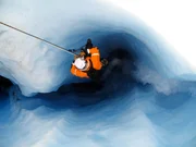 A top shot of Steve Backshall climbing into the moulin on the end of a rope.