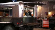 Edd China works on the Humvee.