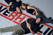 Designer Chip Foose with Co-hosts Courtney Hansen and Chris Jacobs on top of the Overhaulin' logo.