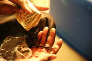 New Orleans, LA, USA: A dealer with a wad of cash and a bag of weed.