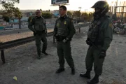 SAN DIEGO, CA, USA: A group of border patrol agents survey the area near the San Ysidro crossing, the international boundary that separates San Diego from Tijuana. The more experience the agents acquire, the easier it becomes for them to determine which vehicles are smugglers hiding both illegal immigrants and people.