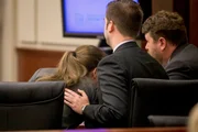Zachary Walden comforts his client Shayna Hubers, 27, as she cries in his lap before the jury delivers her verdict after five hours of deliberation Tuesday, August 28, 2018 at the Campbell County Courthouse in Newport, Kentucky. Hubers was found guilty of murdering her boyfriend Ryan Poston.