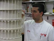 Buddy Valastro works on the Leaning Tower of Pisa cake.