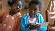 Equadorian children looking at picture of their godparents