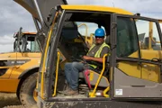 Howie Anderson smiling in excavator