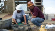 Jason Sanchez and Dave Turin panning for gold