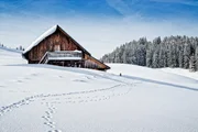 Small wooden hut in the Austrian alps in wintertime