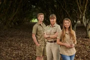 Bindi Irwin, Terri Irwin and Robert Irwin in tree grove.