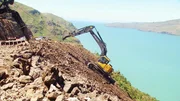 Christchurch New Zealand. Operator removing loose rocks to earthquake road
