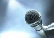 Microphone on a stage with lights for live performance.