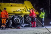 Overhalla, Norway - Snow plow tipped over. Roger Heggli attaching a wire to the plow.