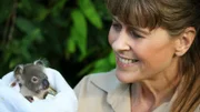 Terri Irwin holding a baby koala.