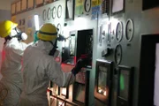 DRAMATIC REENACTMENT: Workers at the Fukushima Nuclear Power Plant in the control room testing if connecting car batteries is providing power to equipment.  (Photo Credit: © Darlow Smithson Productions Ltd)