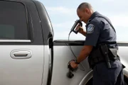 Mayaguez, Puerto Rico, USA: CBP Officer Figueroa uses an LED fiberscope to inspect the  gas tank of a vehicle that arrived on a Mayaguez ferry boat.