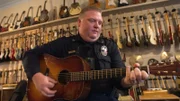 Policeman plays the guitar.