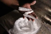 MEXICO- A dealer holding some shards of crystal meth that he has cooked.