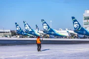 Series of Alaska Airlines planes lined up on apron