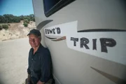 Mike Rowe, host of Dirty Jobs, poses with the Rowe'd Trip RV.