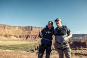 Bear Grylls and Rainn Wilson wait to be picked up after their journey. (National Geographic/Ben Simms)