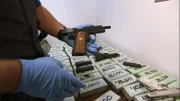 Nogales, AZ: A CBP officer unloading confiscated and packaged weapons. Some of the items seized will be used to conduct research on the cartel which was running the smuggling operation.