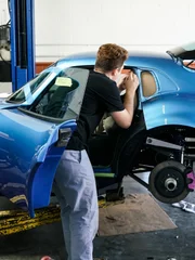 A-Team member Fabian Fioto works on the side windows of Marissa Campbell?s Shelby Daytona.