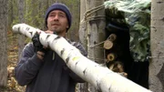 Matt hauls a log for the trapper shack.