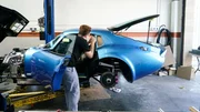 A-Team member Fabian Fioto works on the side windows of Marissa Campbell?s Shelby Daytona.