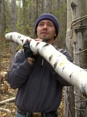 Matt hauls a log for the trapper shack.