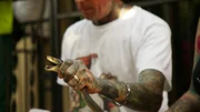 Simon Key's hand holding a deadly black mamba (Dendroaspis polylepis) behind the neck. This is a humane technique of securing the snake referred to as 'necking', ensuring the snake isn't harmed, and the snake handler is safe from a potential bite.   (National Geographic/Dylan Theron)