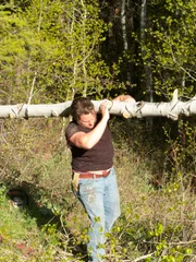 Gabe Brown cuts down tree to create wedding ceremony arch.