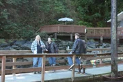 Billy, Bam, Gabe and Bear standing, waiting on a bridge.  Can’t see Bear’s face.