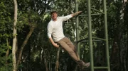 Expedition Unknown crew member Aaron Schoonhoven hangs off a structure in this behind the scenes photo from El Mirador, Guatemala.