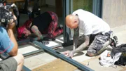 Simon Keys and Siouxsie Gillett searching for a suspected snake in a door frame. (National Geographic/Daniel Philogene)