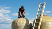 Gabe sourcing water tanks at junkyard.