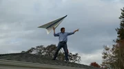 Kevin on his roof testing out a large paper airplane.