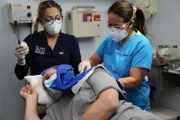 Dr. Lee and assistant operate on David's neck.