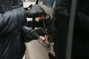 Male thief trying to open car