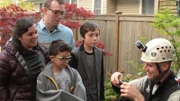 Shaun Sears holds Snow in a cat bag, presents him to the Heinrich family: Peter, Angie, Aden and Zane.