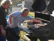 Joy's husband, Buddy, prepares the food for Bo's fundraiser.