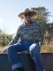 Ray Matherne sailing his motorboat along the river.