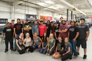 Entire Spark Motors team with Chuck Norris and his wife.