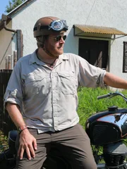 Josh Gates on his motorcycle in the Hungarian countryside.