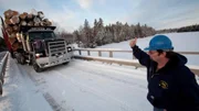 Rudy Pelletier (in blue sweatshirt) and a logging truck with 275,000 pounds of timber driven by Lester Dube on a worksite at the Pelletier's vast logging operation in Northern Maine.